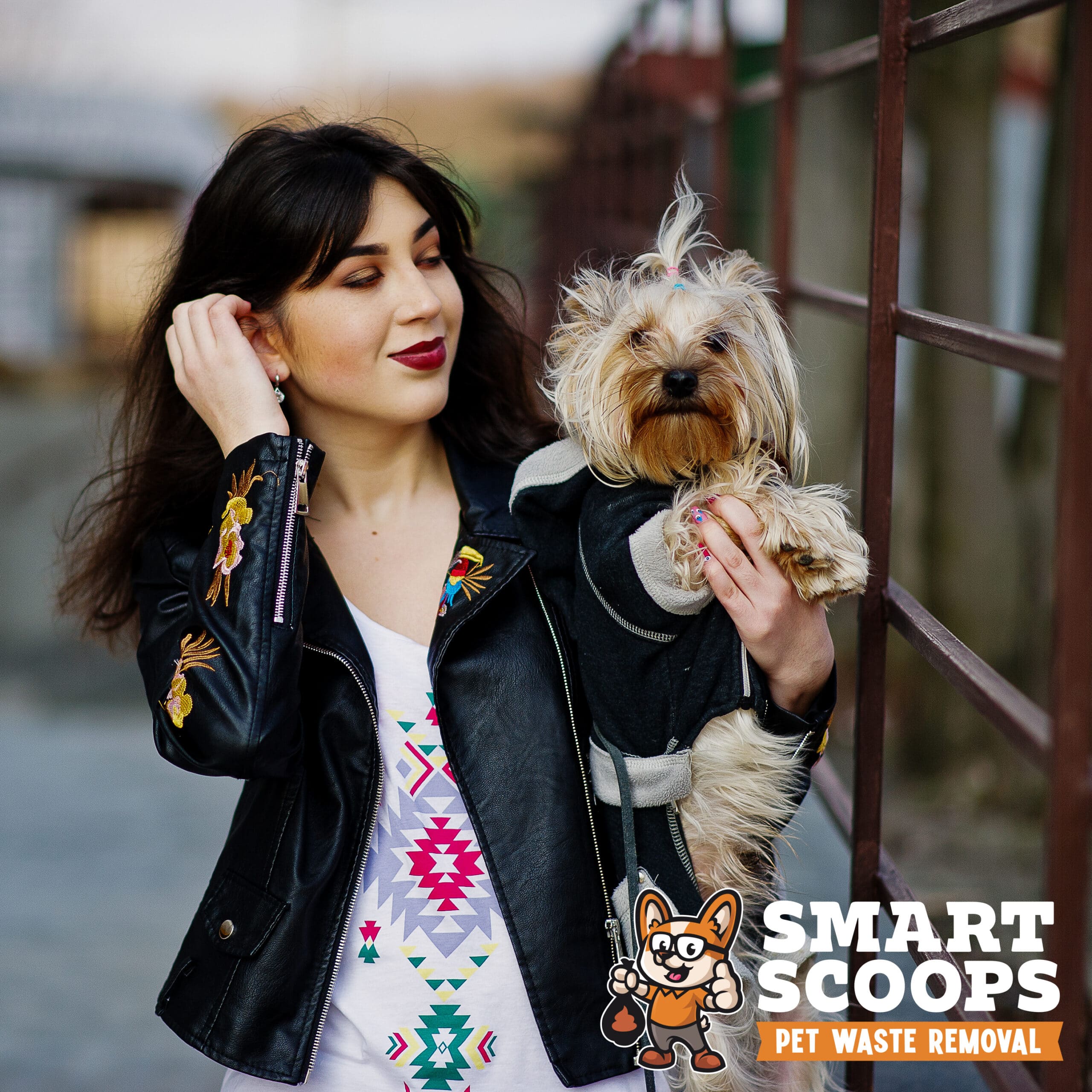 Brunette gypsy girl with yorkshire terrier dog posed against ste